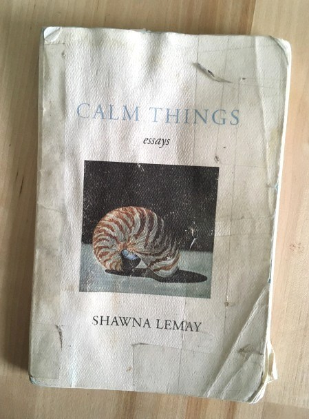 This colour photograph shows the front cover of a battered and worn copy of the book Calm Things by Shawna Lemay., published by Palimpsest Press.